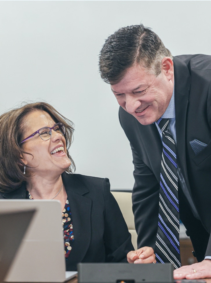 Serva Health founders Ken and Lucine King reviewing ServaCore™ technology for patient support programs.