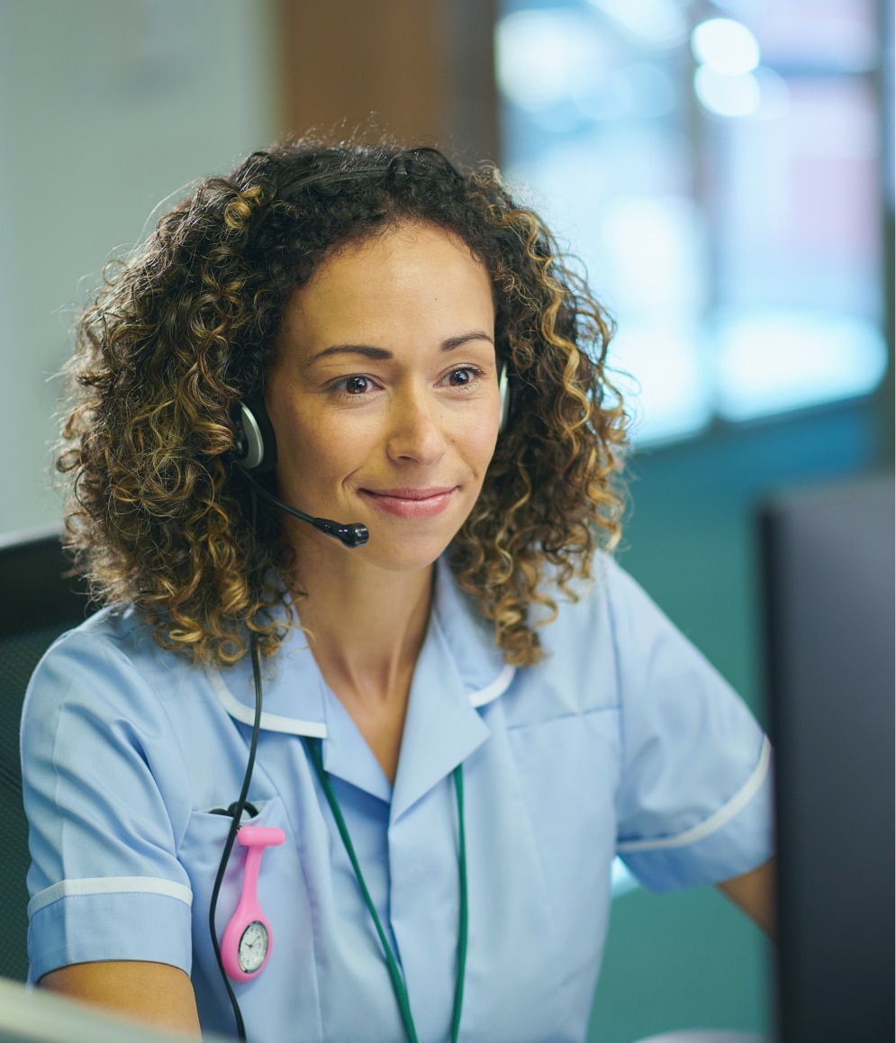 Nurse on a call delivering virtual injection training and patient assistance programs with a headset.