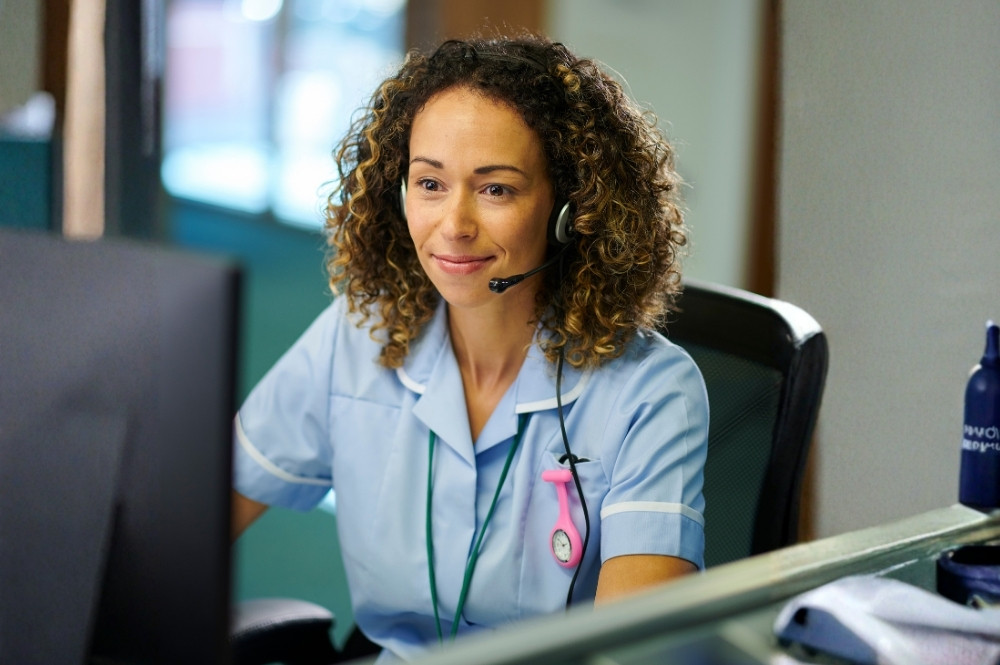 Nurse providing clinical trial participant support at a dedicated call center, ensuring patient engagement and efficient study coordination.