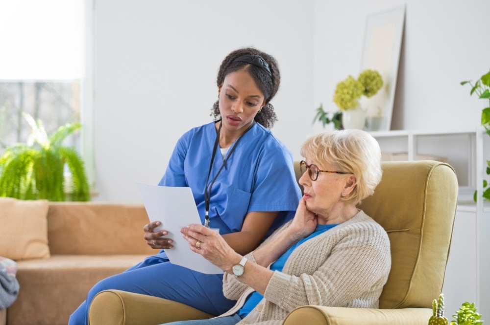 Nurse helping patient review co-pay assistance navigation options for treatment access