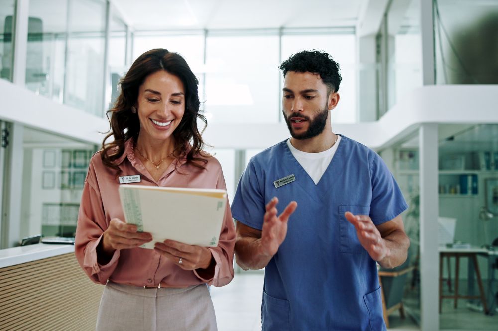 Healthcare professionals reviewing patient information to support reimbursement programs and specialty therapy access