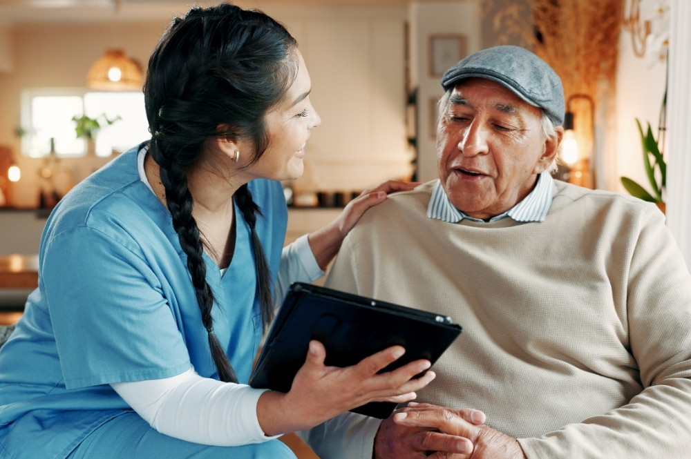 Nurse helping patient use a tablet for digital health technologies in clinical trials